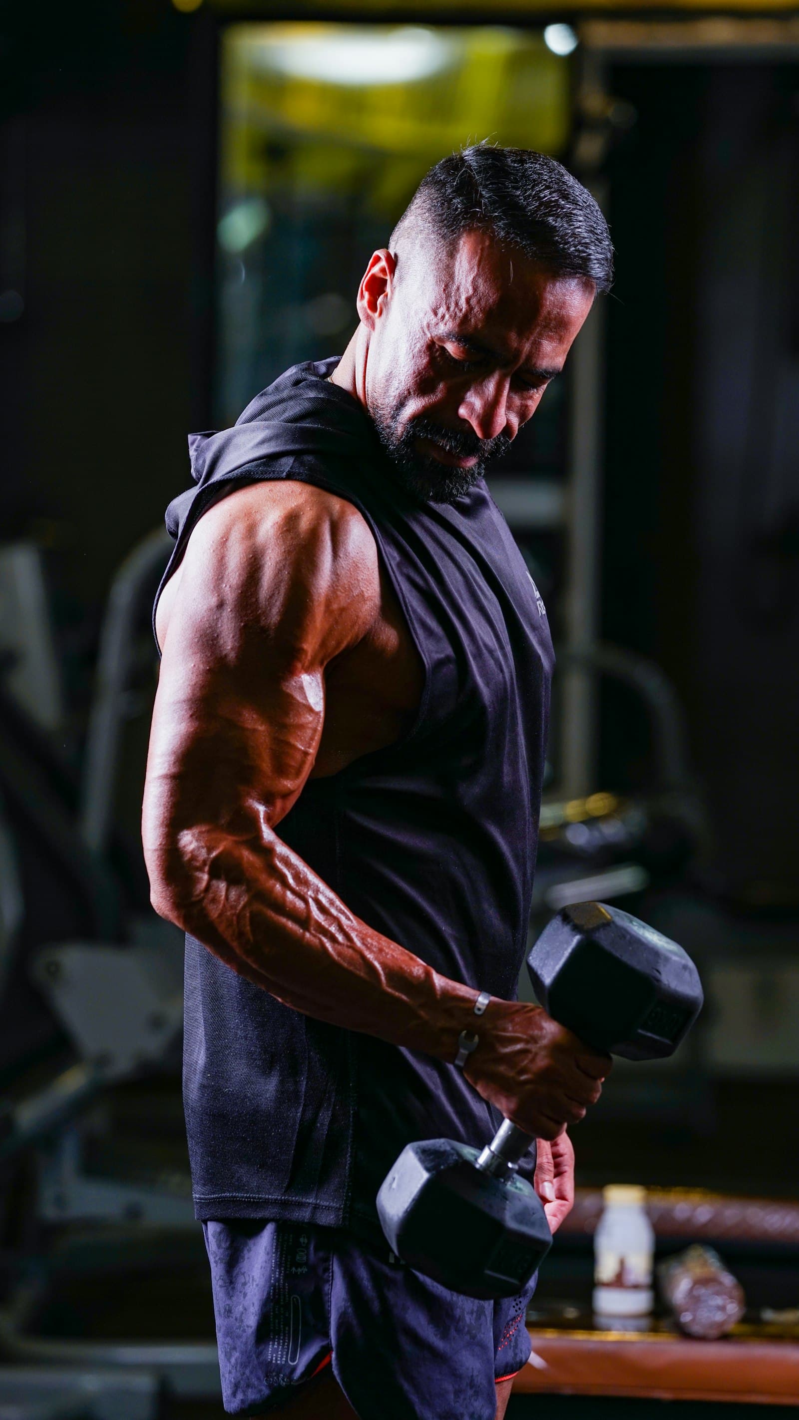 Man training with dumbbells in a gym