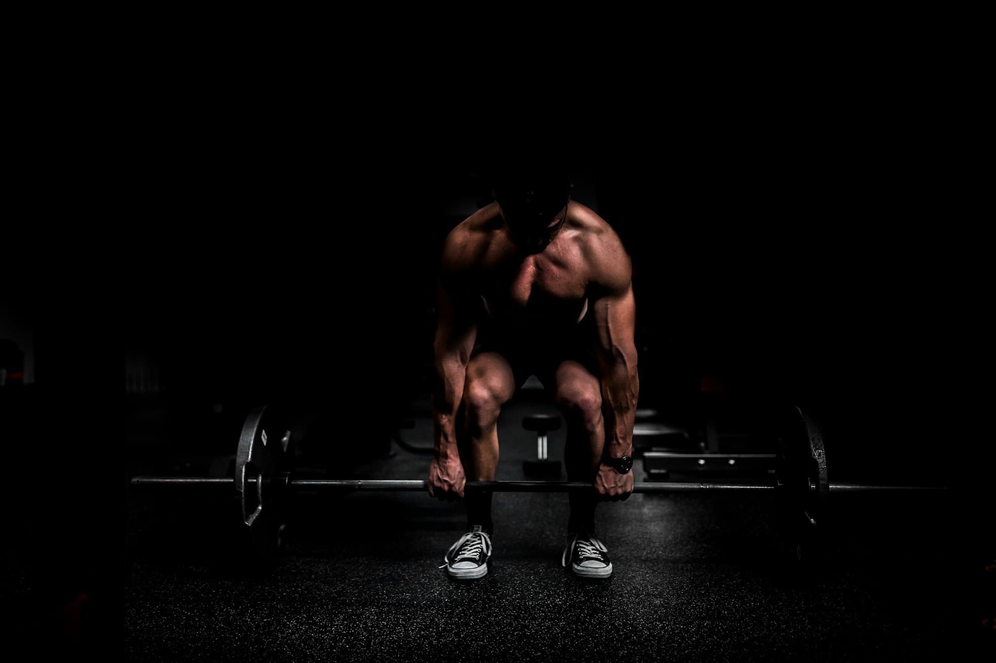 Man completing a heavy deadlift in a gym
